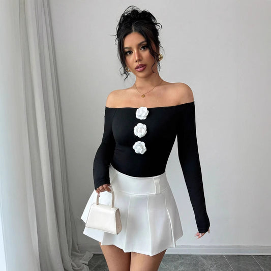 Woman wearing black 3D Floral Off The Shoulder Slim Fit Long Sleeved T Shirt with white flowers and white skirt